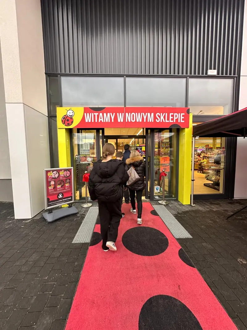 Red carpet in front of the store entrance on the opening day