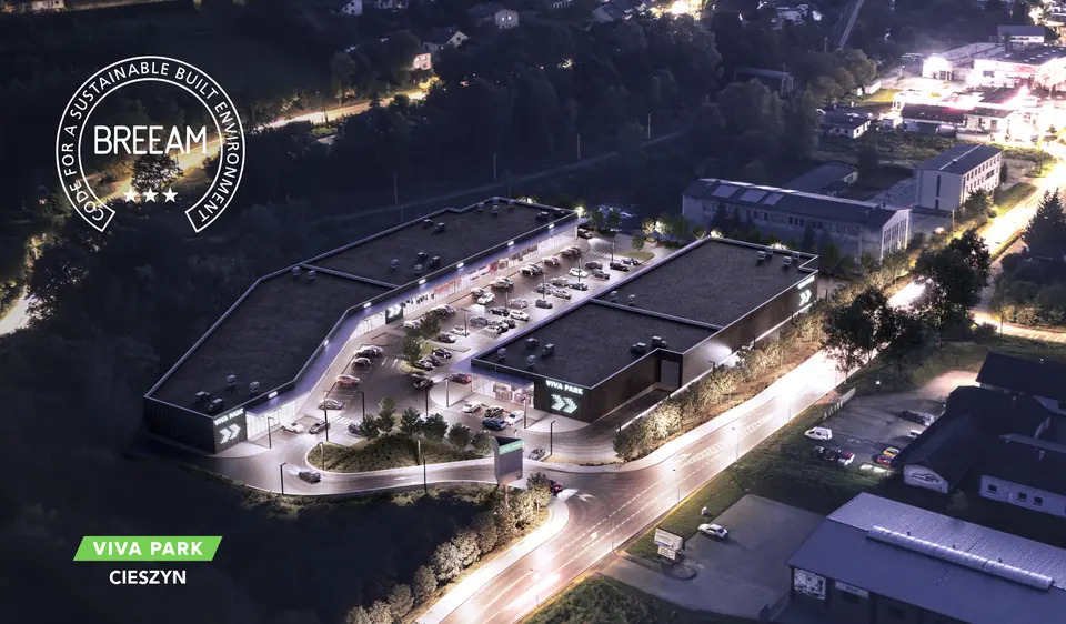 Night-time visualisation of the Viva Park Cieszyn retail park with the BREEAM certificate mark