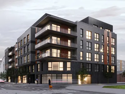 Corner residential and commercial building on ul. Wierzbowa at dusk
